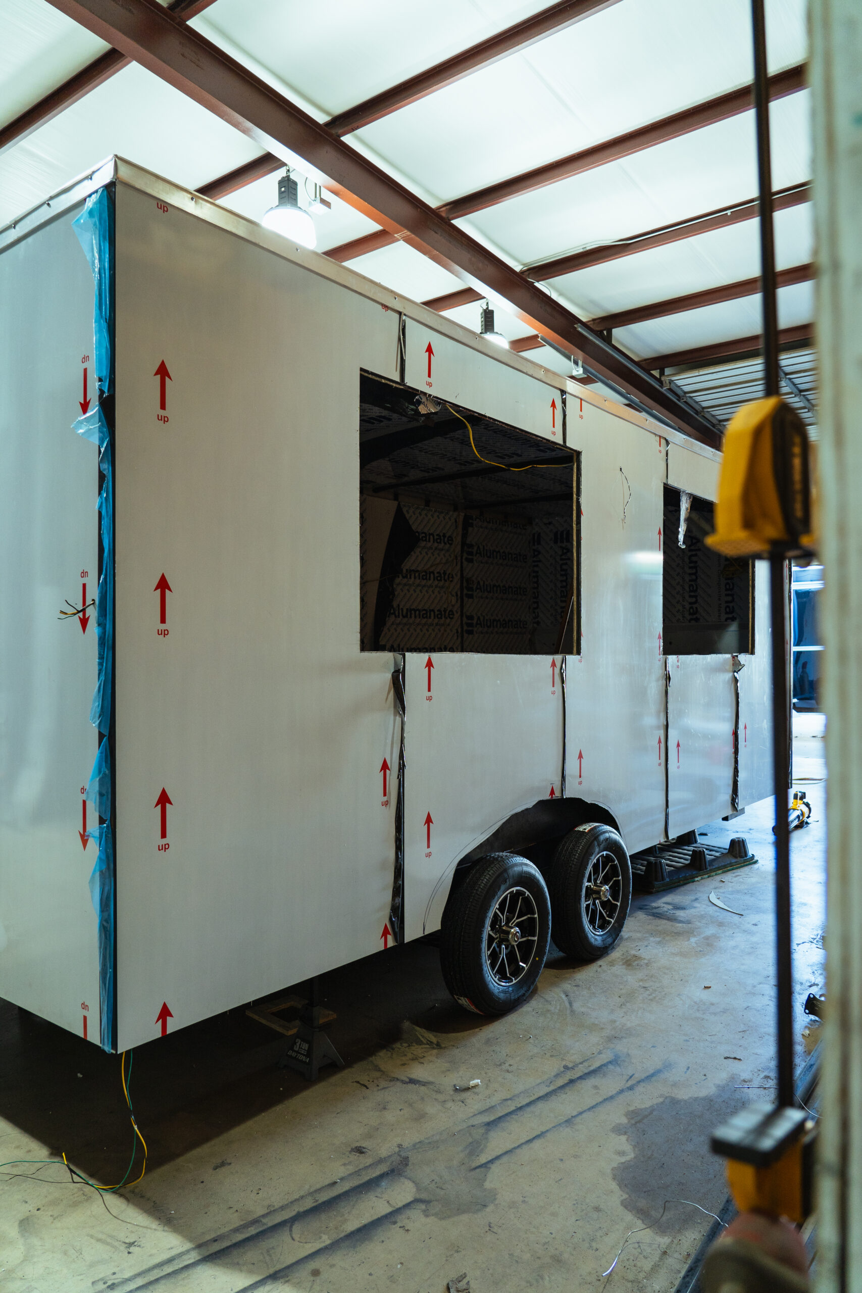 Food trailer under construction with window openings inside the workshop