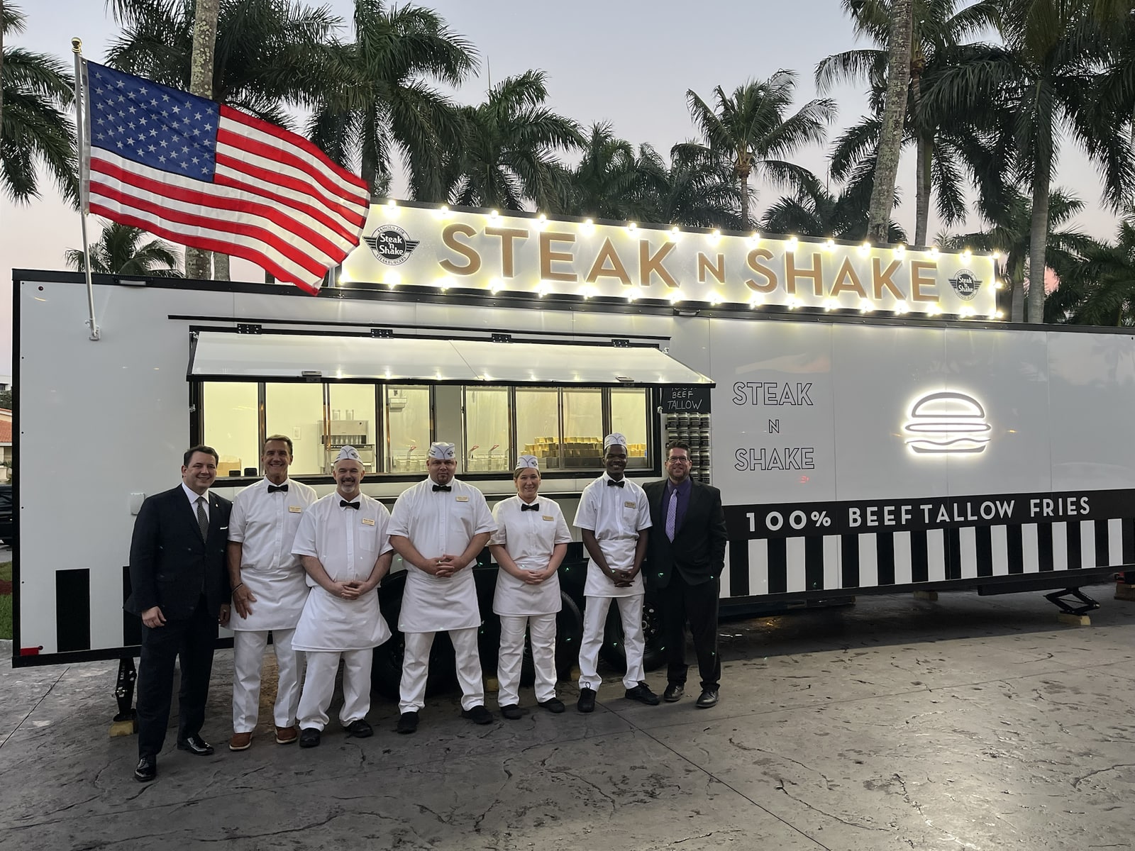 The team gathered in front of the Steak n Shake food trailer