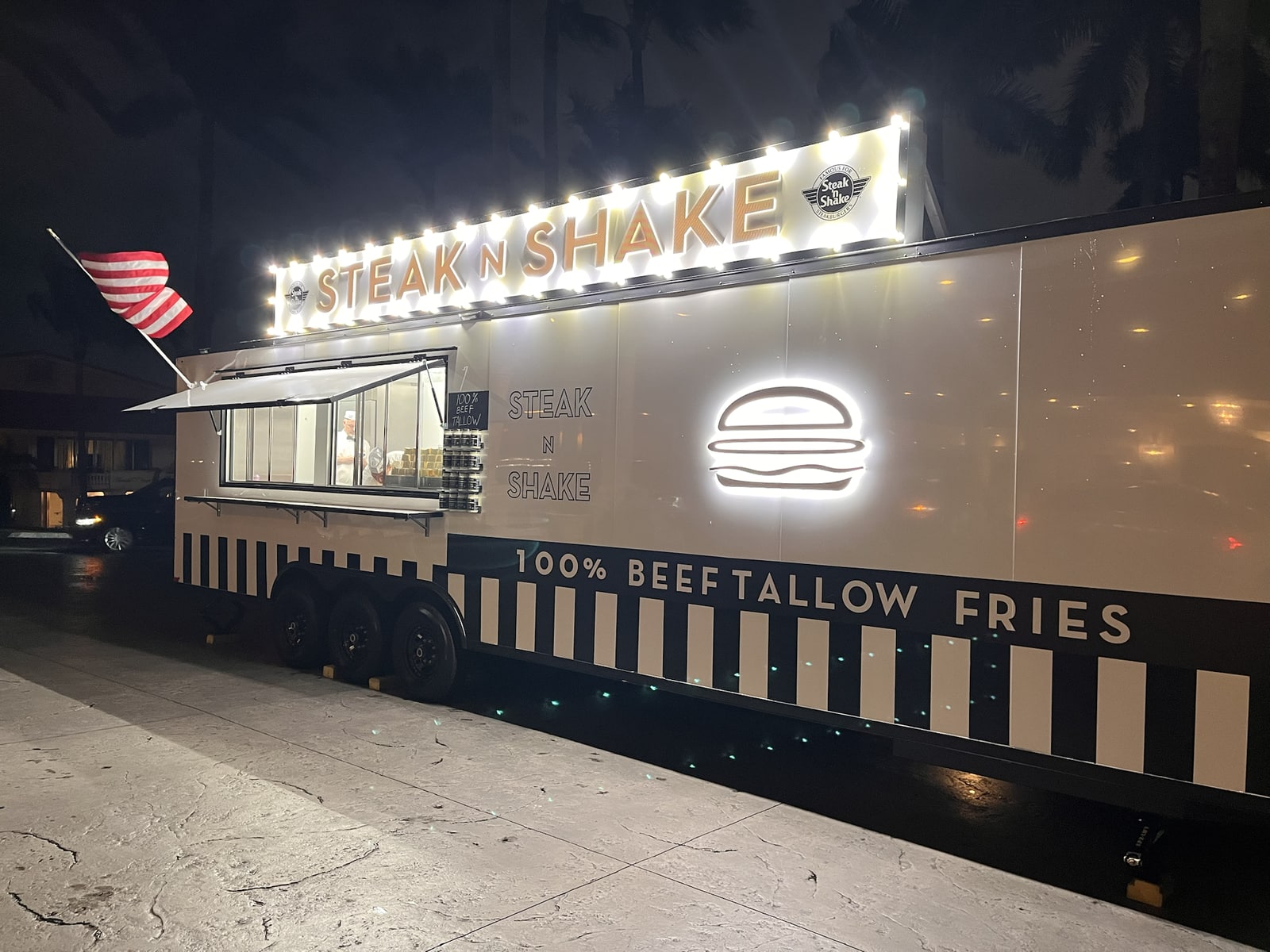 Steak n Shake food trailer with illuminated signs at night