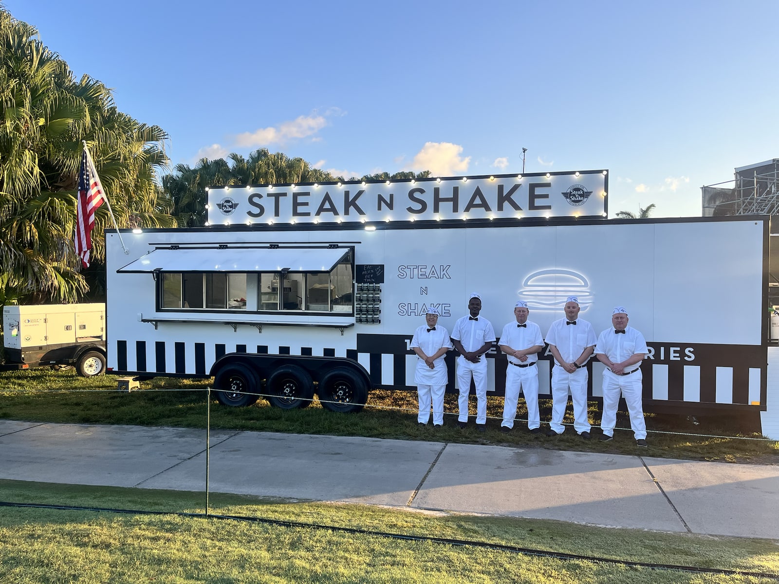 Steak n Shake team standing beside their food trailer