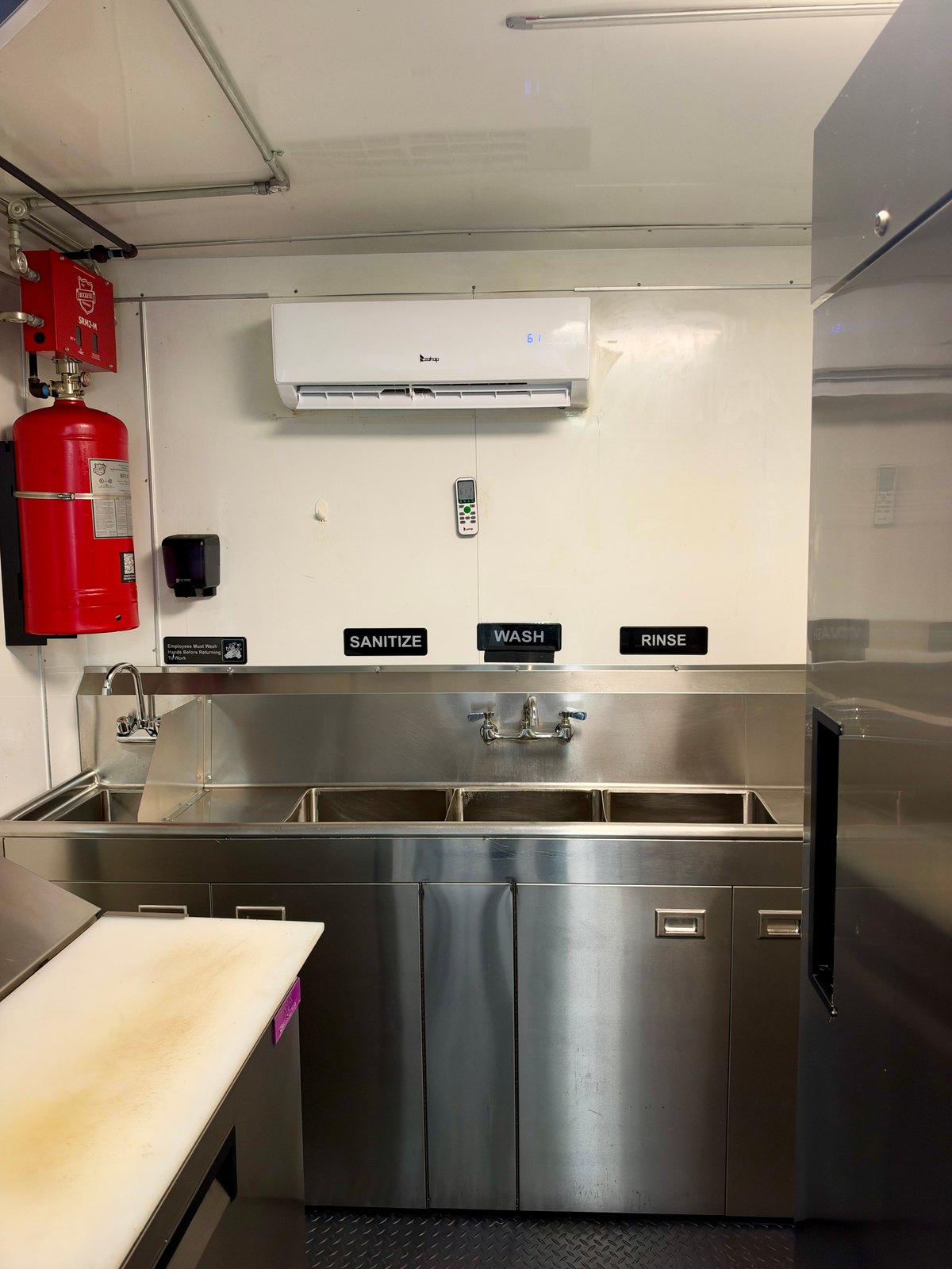 Pre-owned black 8.5 × 16 ft trailer — Interior sink area