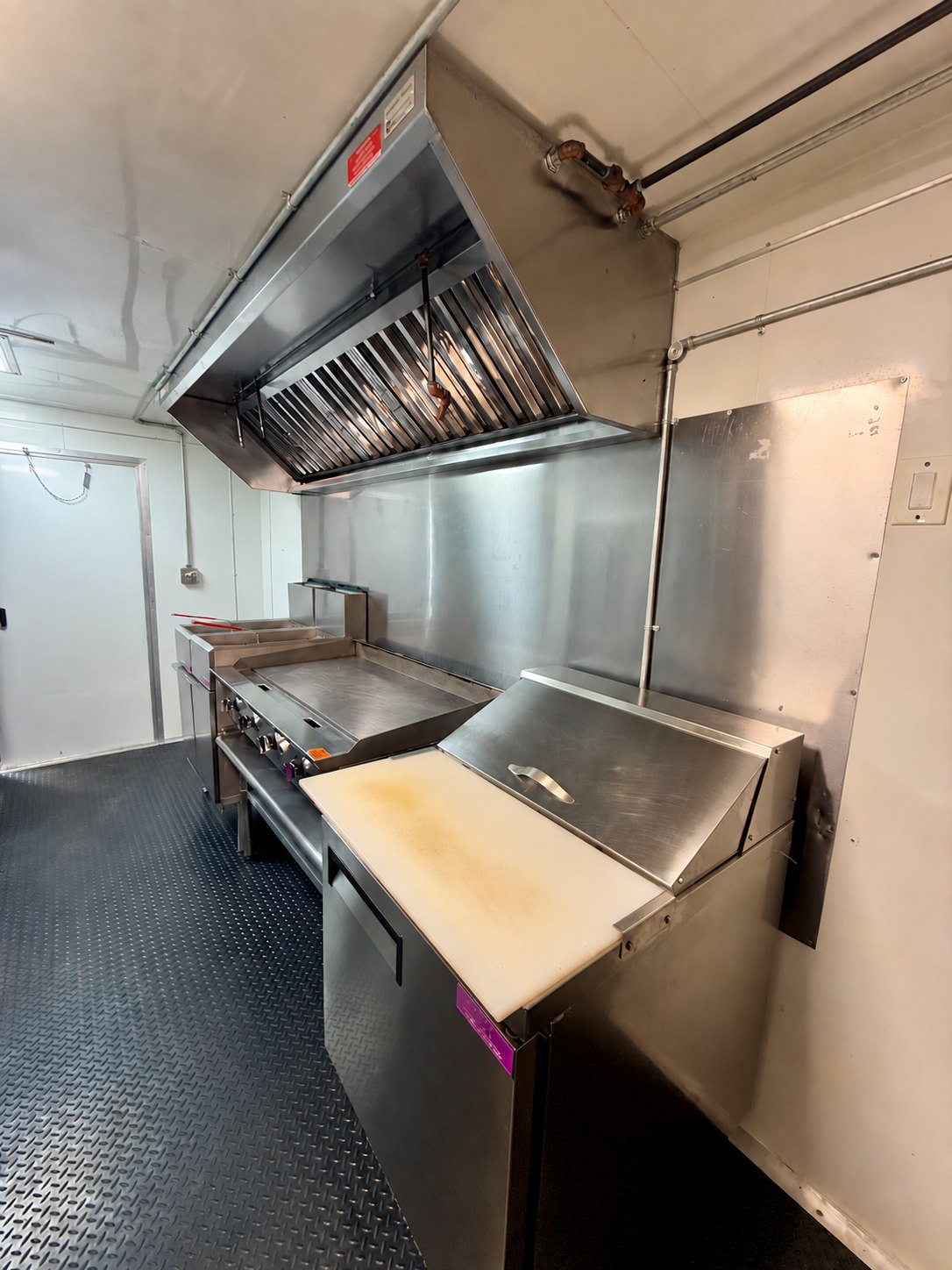 Pre-owned black 8.5 × 16 ft trailer — Griddle and sandwich preparation station