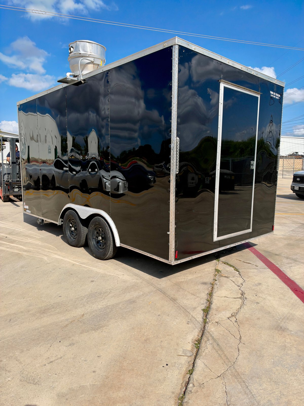 Pre-owned black 8.5 × 16 ft trailer — Rear and opposite-side exterior