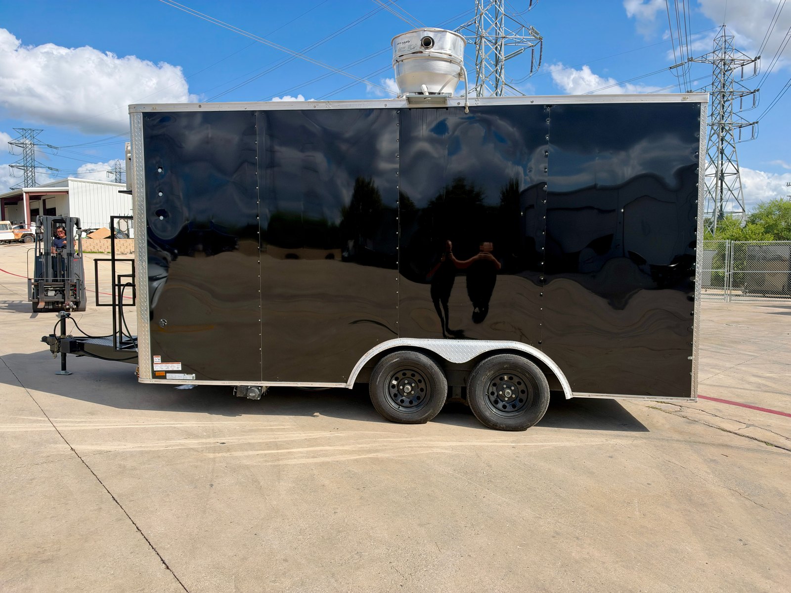 Pre-owned black 8.5 × 16 ft trailer — Opposite-side exterior