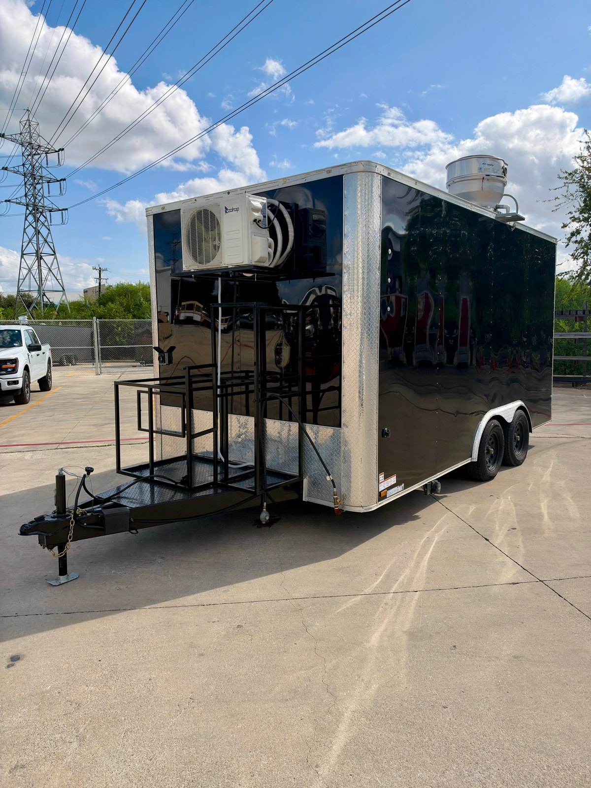 Pre-owned black 8.5 × 16 ft trailer — Front and opposite-side exterior