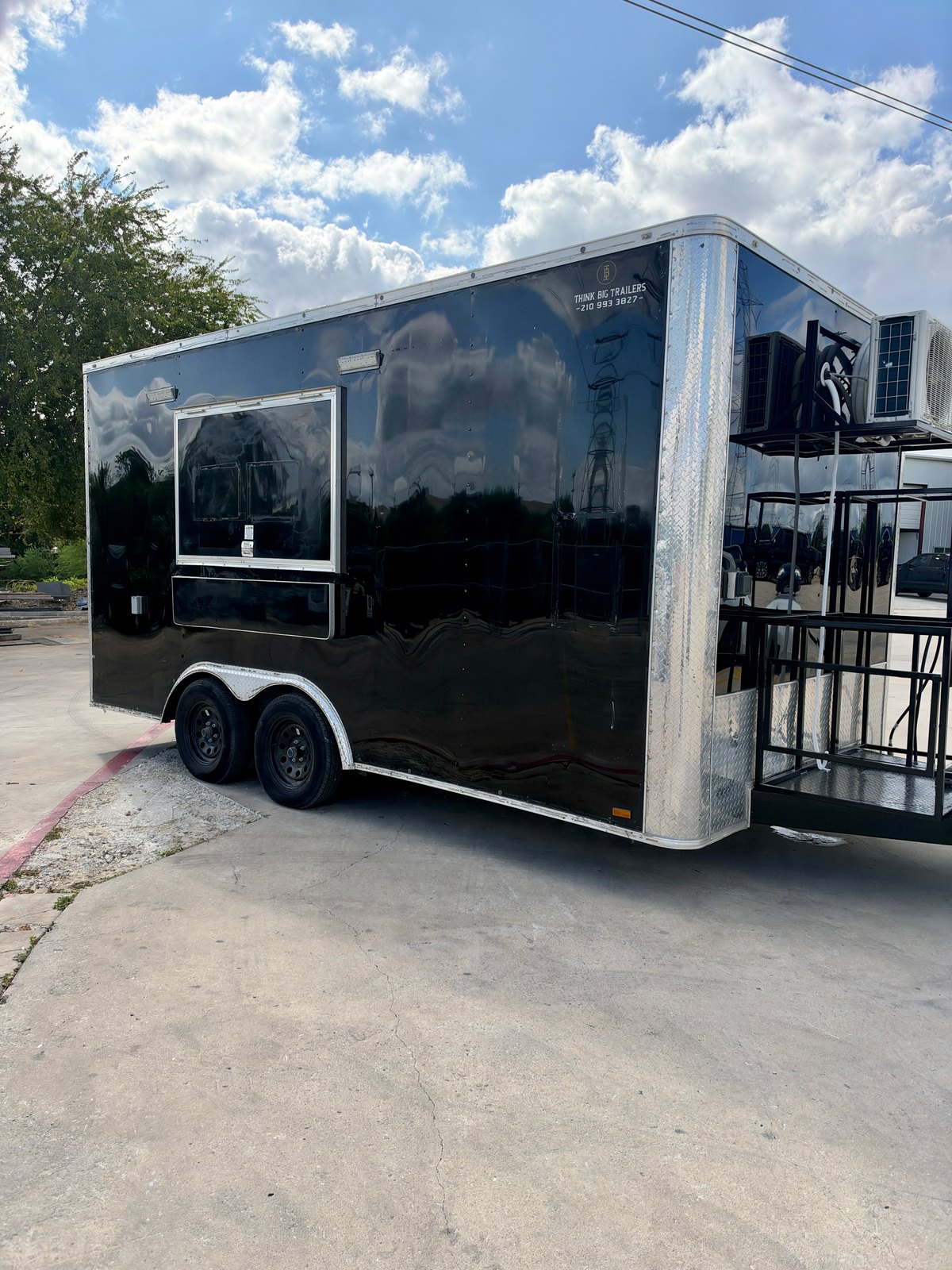 Pre-owned black 8.5 × 16 ft trailer — Front and service-side exterior