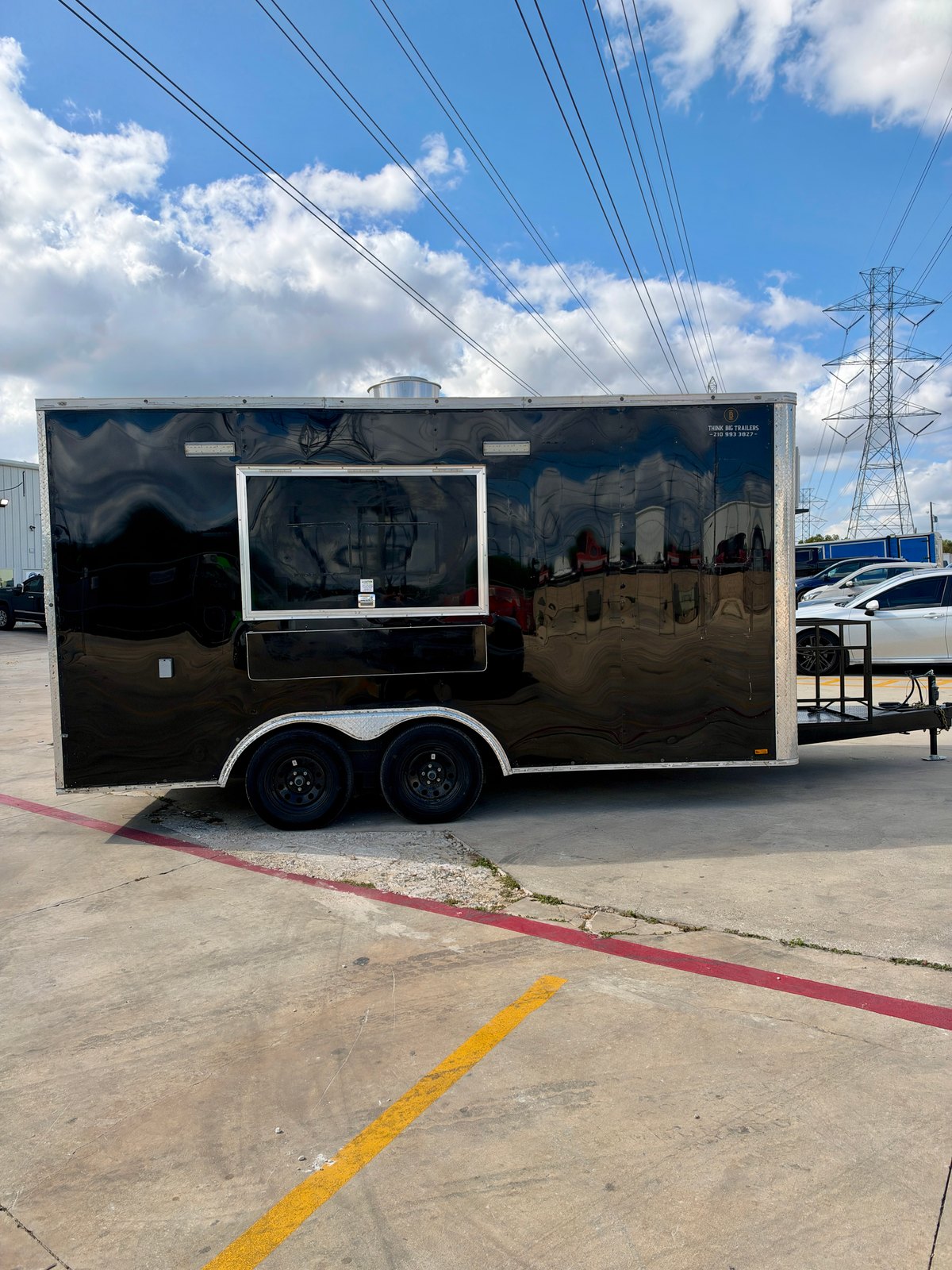 Pre-owned black 8.5 × 16 ft trailer — Service-side exterior