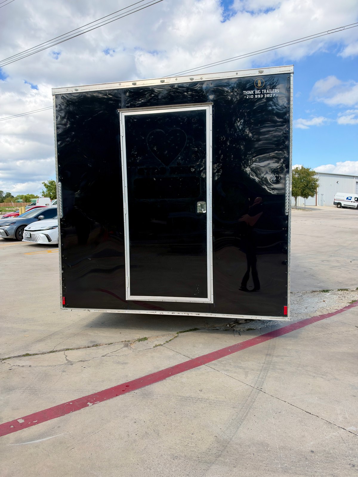 Pre-owned black 8.5 × 16 ft trailer — Rear entry door