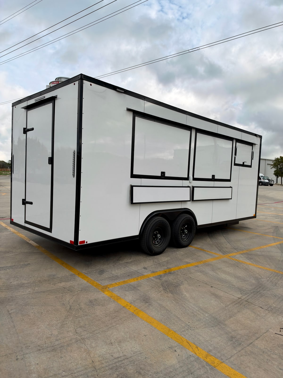 White 8.5 × 20 ft trailer — Rear and service-side exterior