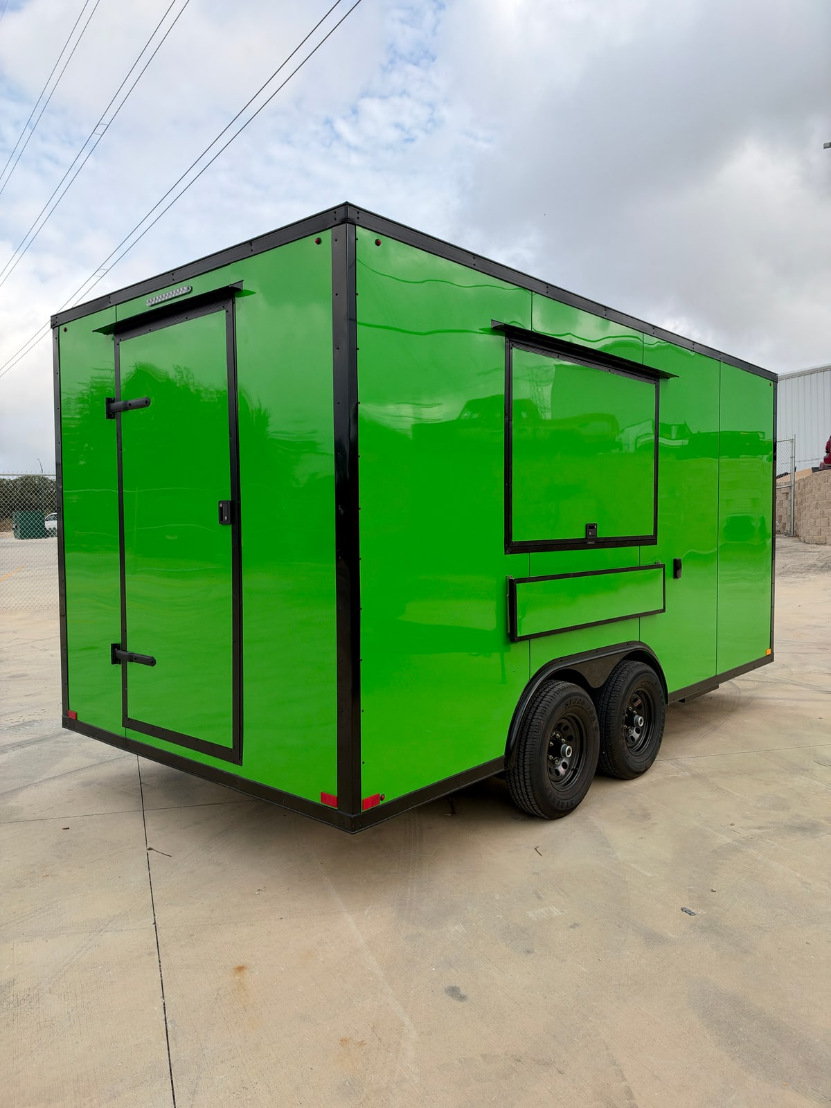Green 8.5 × 16 ft trailer — Rear and service-side exterior